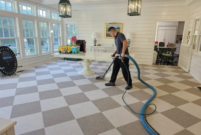 Sherlock Holmes Cleaning technician doing hot water extraction carpet cleaning in a Cape Cod, MA home