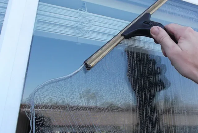 Professional window cleaning on a home in Cape Cod, MA