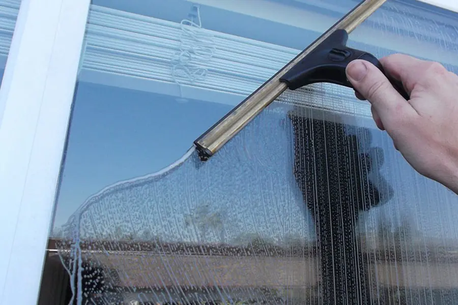 Professional window cleaning on a home in Cape Cod, MA